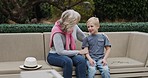 Senior woman and grandson bonding together in a garden with conversation and support. Love, relationship and advice with a hug from grandmother to relax during discussion with family