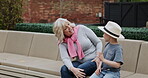 Senior woman and grandson bonding together in a garden with conversation and care. Love, putting on a hat and grandmother relax with family child