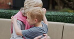 Senior woman and grandson bonding together in a garden with conversation and support. Love, relationship and advice with a hug from grandmother to relax during discussion with family