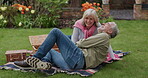 Couple, love in a garden on a picnic for a romantic holiday or vacation in spring. Happy senior man and woman bonding and relax in retirement