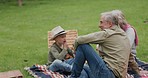 Grandson, family in garden on a picnic on holiday or vacation with a boy. Happy grandparents, man and woman with child bonding and relax