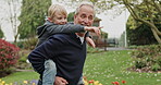 Grandfather piggyback young boy in garden, park and outdoor for love, care and fun. Senior man carrying happy kid while walking, talking and pointing in nature