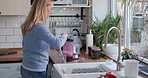 Woman in kitchen with blender, fruit smoothie with health and wellness, weight loss diet in home. Nutrition, vegetables and healthy food, girl in house with protein shake or juice glass at breakfast.
