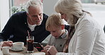 Coffee shop, breakfast with grandparents and a boy using his phone in the morning while eating food. Family, grandmother and grandfather with their child grandson in a restaurant together for bonding