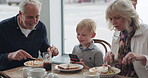 Restaurant, breakfast with grandparents and grandson using his phone in the morning while eating food. Family, grandmother and grandfather with their boy grandchild in a cafe together for bonding