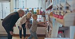 Shopping, grandparents and choice of candy for a child at a shop or sweets store shelf. Senior man, woman and a boy kid or customer buying sugar treats from small business on family travel trip