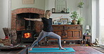Stretching, yoga and fitness with woman in living room for mental health, spiritual and relax. Zen, meditation and balance with female person at home for energy, floor workout and mindfulness 