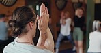 Yoga, class and eagle pose for meditation of man in training, holistic workout and flexibility. Yogi, fitness group and people stretching hands, exercise and wellness for healthy body in gym together