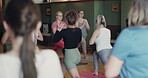 People, yoga and instructor in studio, training and body balance for wellness, core strength and spiritual wellbeing. Exercise, class and stretching for mindfulness, meditation and healthy lifestyle