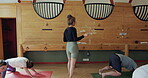 Fitness, yoga instructor and people exercise for health and wellness. Men and women group in gym class for mindfulness, workout and healing or relax with downward pose, stretching and pilates
