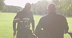 Elderly friends, golf course and man in wheelchair to play game, training and competition for recreation. Sports, golfer and person with disability with golfing club, ball and learning for fun hobby