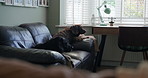 Cute, relax and dog pet on a sofa in the living room of a modern apartment on a weekend morning. Calm, sweet and brown puppy animal laying and resting on the couch in lounge of home or house.