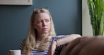 Face, woman and coffee for relaxing on sofa in living room for delicious, aroma or taste. Female person, glasses and thinking by looking out window with hot beverage, tea or latte for comfort in home