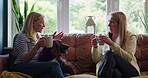 Coffee cup, relax friends and people conversation, talking and speaking in morning chat, communication or discussion. Pet dog, lounge couch and home women consulting, gossip and listening to story