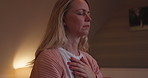 Relax, meditation or zen with a woman in the bedroom of her home in the night for insomnia relief. Peace, mindfulness or awareness with a sleepless mature person sitting on a bed in her apartment