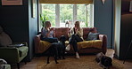Tea cup, friends conversation and women listen to discussion, communication and consulting on story, news or gossip. Lounge sofa, pet animal dogs and home people sit together, relax and drink coffee