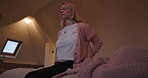 Woman, back pain and injury on bed in bedroom with osteoporosis, eyes closed or medical risk at home. Healthcare, person and health crisis with backache or discomfort from bad posture or tension