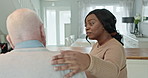 Woman, nurse or volunteer with senior patient in support, help or care at old age home. Calm female person, caregiver and elderly man talking in medical aid, health or assistance at retirement house