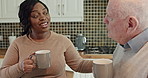 House, drink and couple with talking or support, kitchen and interracial love with laughing in retirement. Elderly man, woman and chat with espresso coffee in morning and care together in apartment