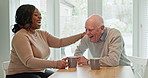 Apartment, drink and couple with laughing or bonding, kitchen and interracial love with support in retirement. Elderly man, woman and chat with espresso coffee in morning and care together in home