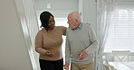 Elderly, man or caregiver with walking stick or support for conversation, helping and happy in lounge. Senior, person or woman with communication, talking or handicap in retirement home for volunteer