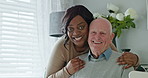 Smile, face and caregiver with senior man in the living room of modern nursing home for assistance. Bond, happy and portrait of black woman nurse with elderly person in wheelchair at retirement house