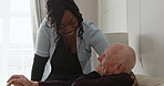 Support, old man with disability and caregiver on sofa talking with homecare, kindness and help in nursing home. Senior care, comfort and advice, elderly person on couch with woman, nurse and chat.