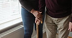Walking stick, help and senior man with disability, caregiver and support for recovery, arthritis or injury. Closeup of hands, elderly person and rehabilitation for mobility, balance and healing