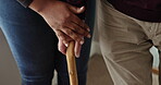 Walking stick, hands and senior man with disability, caregiver and support for recovery, arthritis or injury. Closeup, elderly person and rehabilitation for mobility, joint and muscle pain at home
