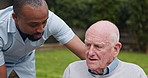 Outdoor, wheelchair and nurse with old man, recovery and support with conversation, help and healing. Pensioner in a garden, person with disability and caregiver with patient, rehabilitation or smile