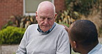 Outdoor, wheelchair and nurse with old man, help and support with conversation, recover and healing. Pensioner in a garden, person with disability and caregiver with patient, wellness and empathy