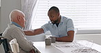 Nurse, support and old man in a wheelchair talking to therapist and advice for healthcare in retirement. Elderly, caregiver and person with a disability or help with kindness or chat on coffee break