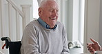 Senior man, laughing and wheelchair in a retirement home with funny joke and happy with a smile. House, comedy and elderly male person with a disability in a living room with conversation and talk
