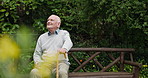 Senior man, park view and relax with garden bench, walking cane and retirement with a smile and calm. Nature, backyard and outdoor with an elderly man with freedom and happy from plants and sitting