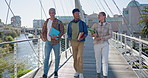 Conversation, walking and students at campus bridge for university education, learning or study. Talking, group and happy friends with discussion outdoor for college, scholarship or entry exam.