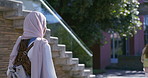 Islamic, back view or college student walking with bag for future or studying in university campus. Travel, leaving or Muslim person with religious clothes for school, education or scholarship