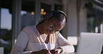 Black girl, laptop and college student with headphones outdoor for learning, music and education. Writing, audio tech and female person study for university, scholarship or admission test in Kenya.