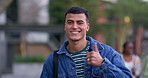 Thumbs up, student and happy on campus for education, knowledge and pride for scholarship. Academic, portrait and hand gesture in university for approval, learning and walk to lecture in Australia
