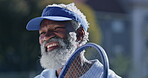 Tennis racket, outdoor sport and mature man with smile for fitness, workout or challenge in UK. Black male person, exercise and training for game, match or tournament in competition, play or activity