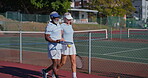 Senior, talking and walking with interracial couple on tennis court for retirement or sports together. Exercise, fitness or hobby with old people in conversation for activity, bonding or training