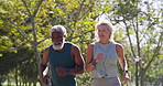 Fitness, running and mature couple in park for exercise, wellness or competitive race. Interracial partners, energy or action on path for challenge, healthy body or support in relationship for cardio