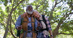 Old couple, hiking and outdoor hug on holiday, fitness adventure and conversation in nature. People, sightseeing and together for embrace in countryside, travel and trekking poles in Mexico forest