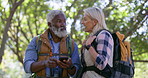 Senior couple, hiking and smartphone for direction, nature and travel with adventure, digital app and forest. Activity, old man and mature woman with cellphone, journey and outdoor with maps and talk