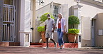 Mature couple, holding hands and happy for on holiday for bonding, break and travel as tourist. Relationship, people and outdoor with smile on summer vacation to relax, enjoy and fun by street