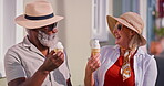 Mature couple, happy and outdoor with ice cream for bonding or fun, break and summer holiday. People, multiracial relationship and laughing or smile on vacation to relax, chill and rest with jokes