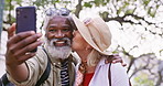 Selfie, hike and senior couple with love, nature or funny with happiness, hug or romance. Outdoor, interracial or mature woman with elderly man, travel or embrace with kiss, picture or capture moment