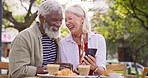 Senior couple, outdoor and phone with food at restaurant for internet, connection and information. Happy, woman and man with tech at table for network, research and online review of meal on website