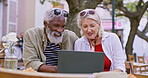 Outdoor, restaurant and senior couple with laptop in discussion for and vacation, update and online info. Food, man and woman with tech by table for holiday, planning and digital travel itinerary