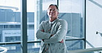 Arms crossed, management and smile with business man at window of corporate office for growth. Company, confident and glass with portrait of mature employee in suit at workplace for development