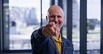 Businessman, face and point with thumbs up in office for project success, motivation and well done. Happy, employee and smile with celebration in lobby for job promotion, selection and good work